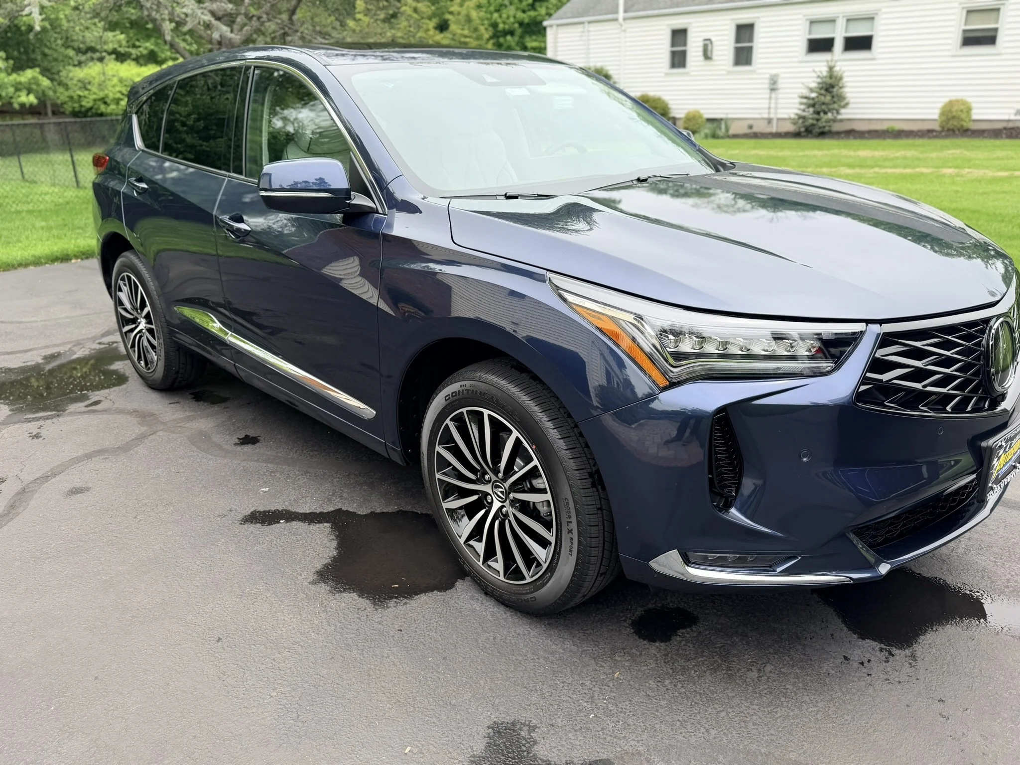Paint correction and exterior detailing on blue Acura MDX.