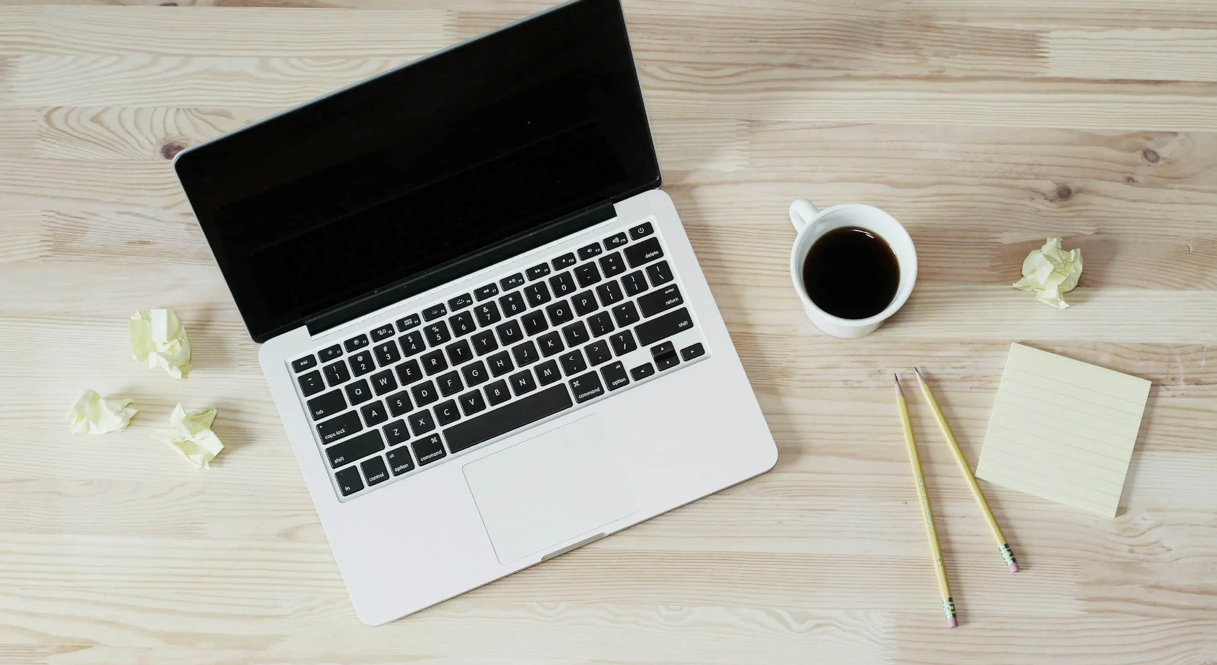 laptop with cup of coffee on desk