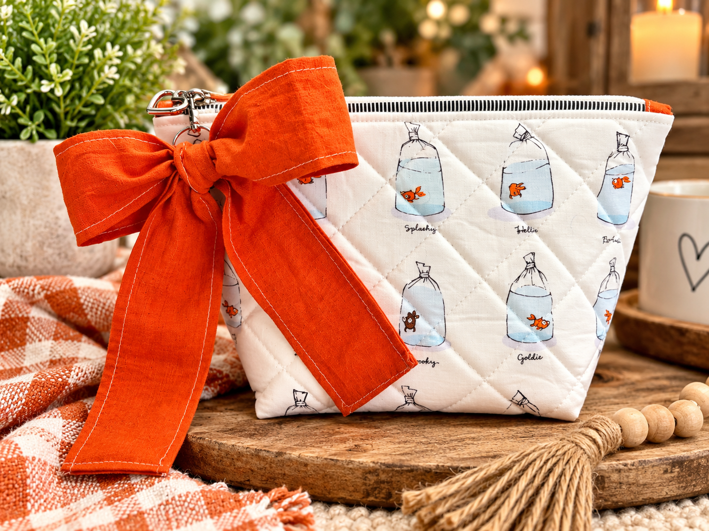 Quilted Goldfish Pouch with Orange Bow.png