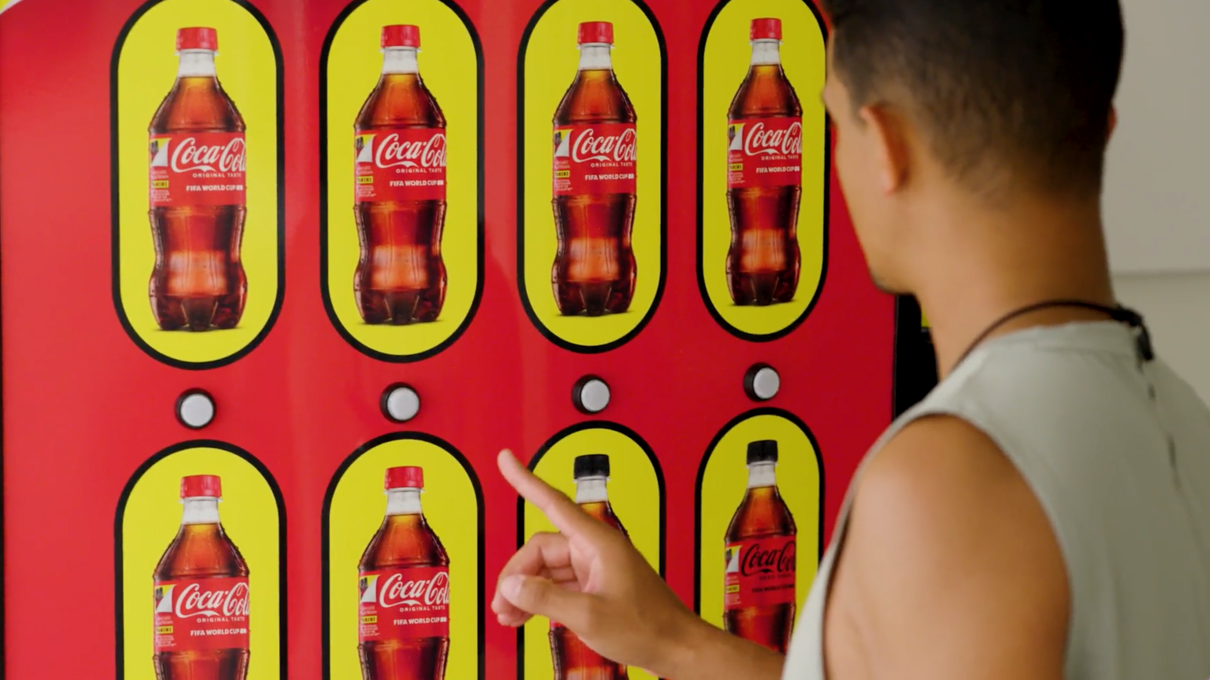 Man deciding and selecting a Coca-Cola bottle from a vending machine
