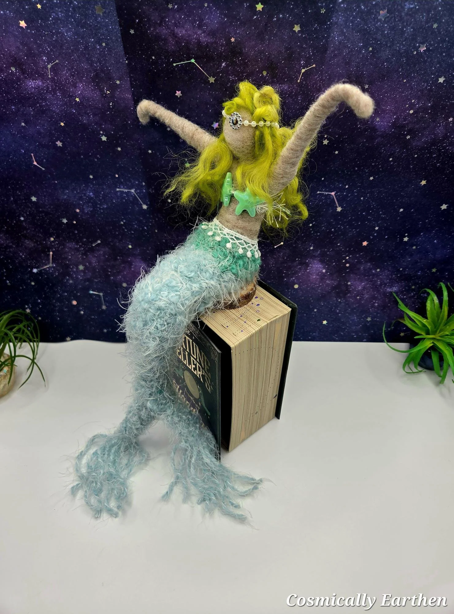Needle felted mermaid art doll with textured seafoam tail and flowing yellow hair, shelf sitter design against starry backdrop