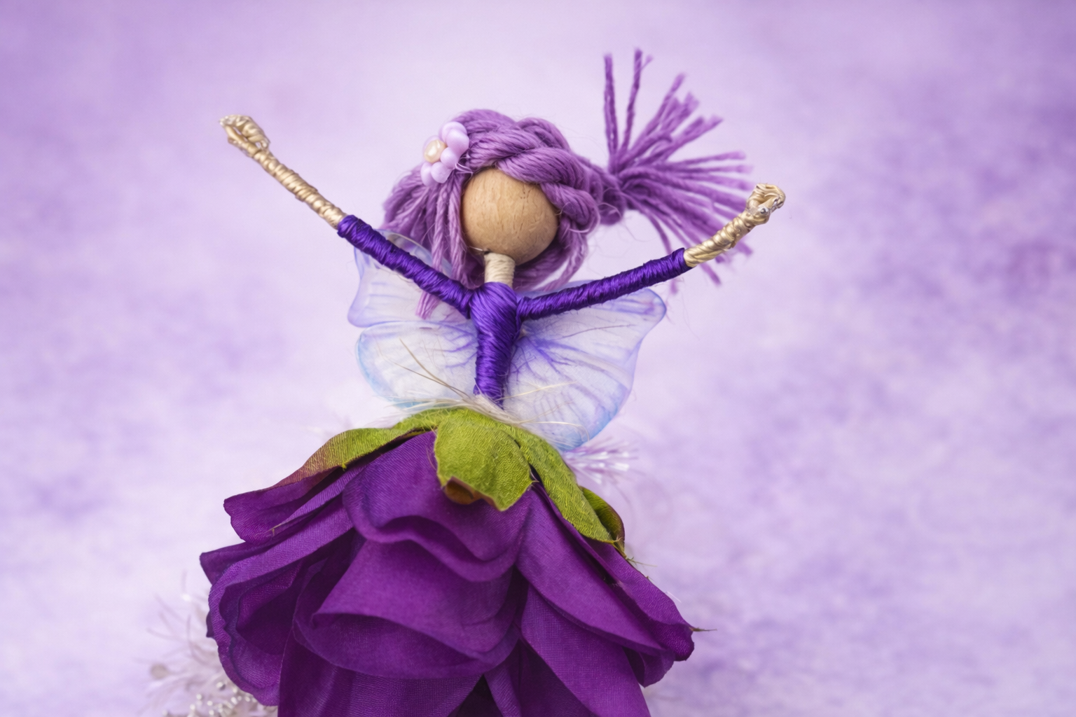 Handcrafted fairy doll with iridescent wings.png