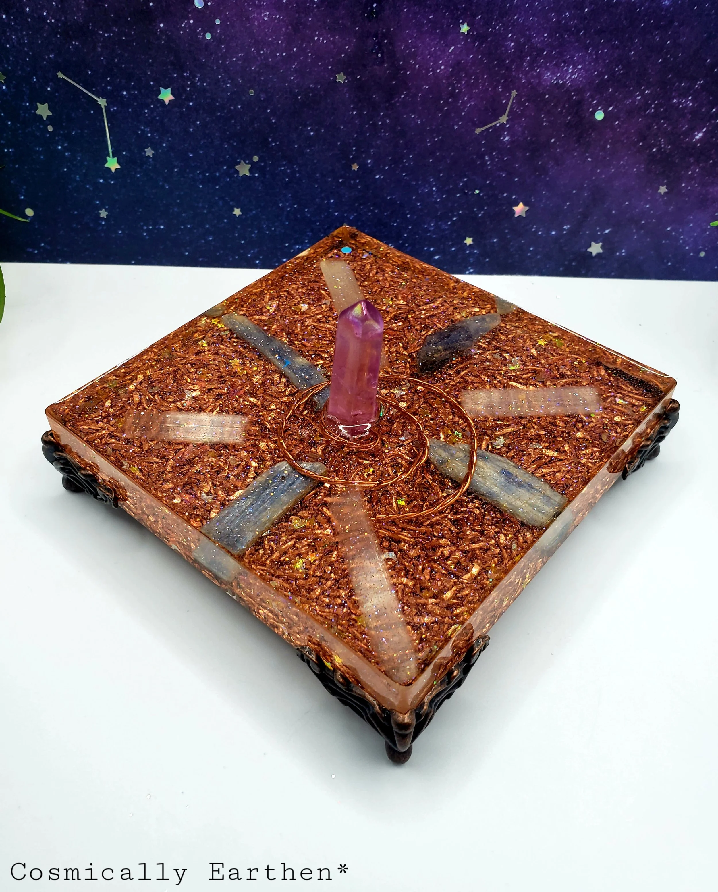 Close-up angled view of orgonite activator showing copper spiral, crystal layout, and shimmering details for high-vibration energy work.