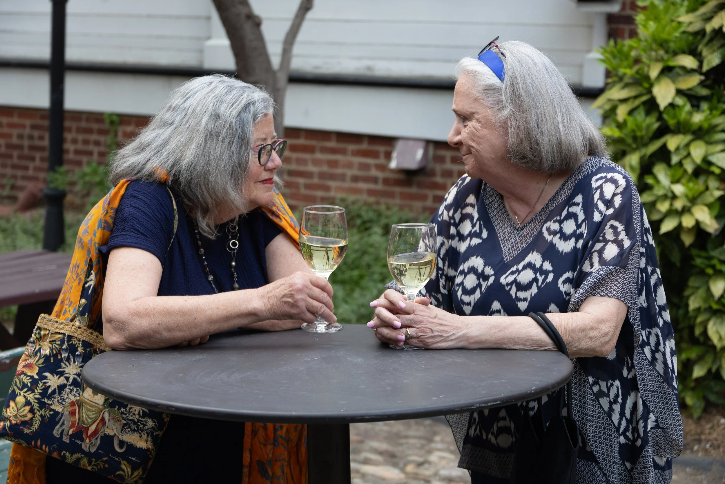 GMTS Spring Fling 2026-Peggy and Friend with Wine in Courtyard.jpg