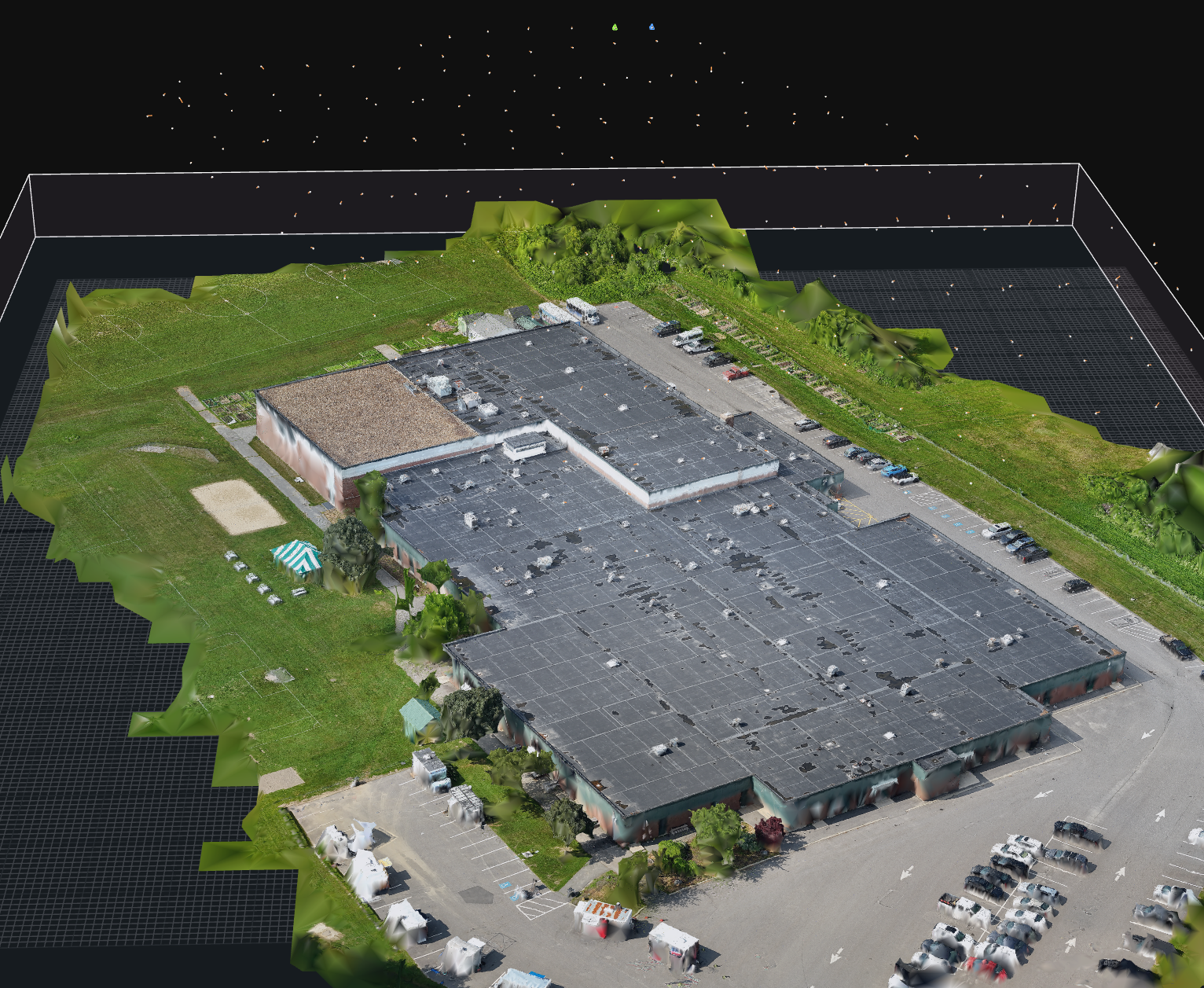 A 3D aerial view of a large retail store with a parking lot, surrounded by grass and trees, with a playground and pathways nearby.