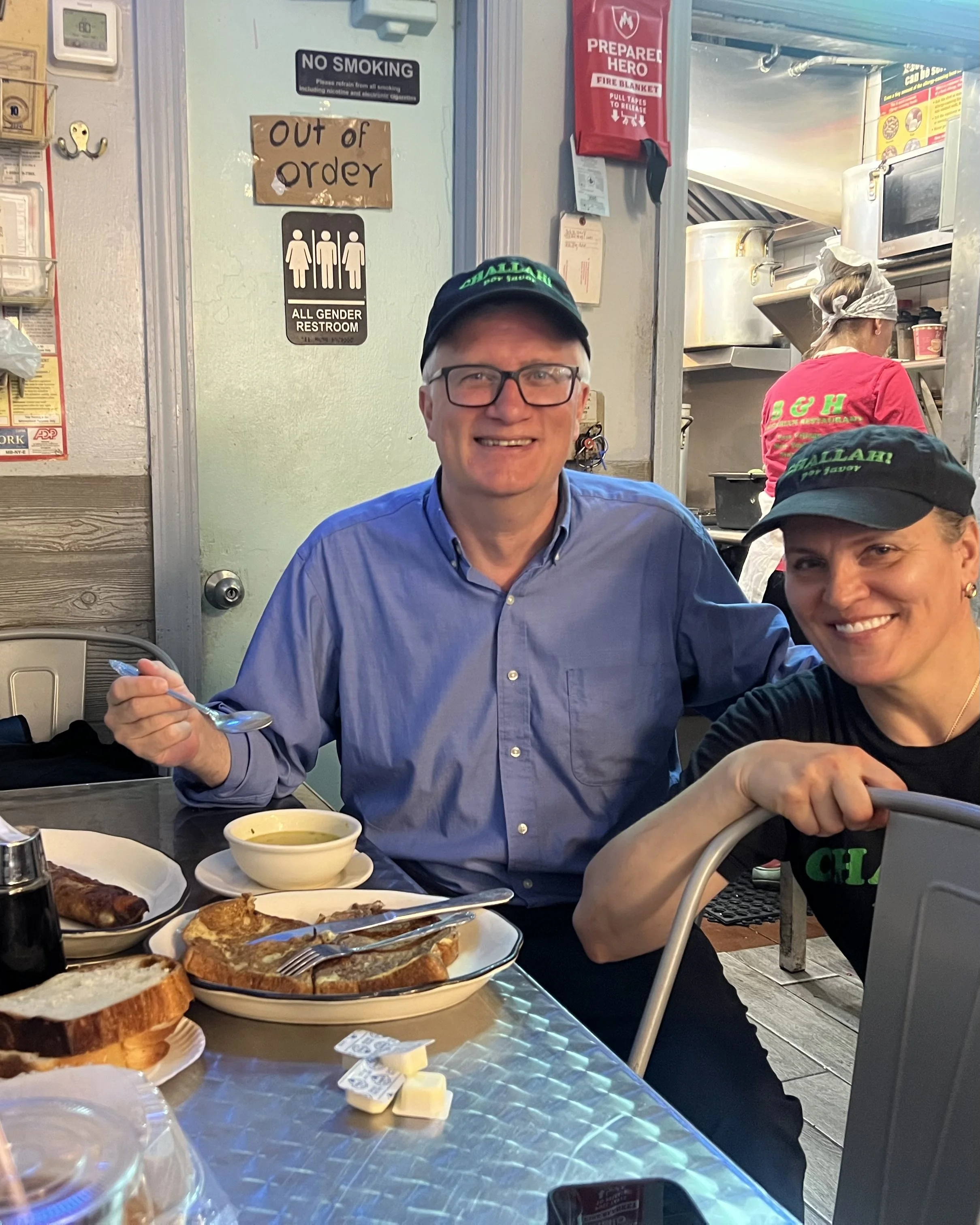 Senator-Brian-Kavanagh-with-BH-Dairy-owner-Ola-and-challah-french-toast-blintz-matzo-ball-soup-at-table.jpeg