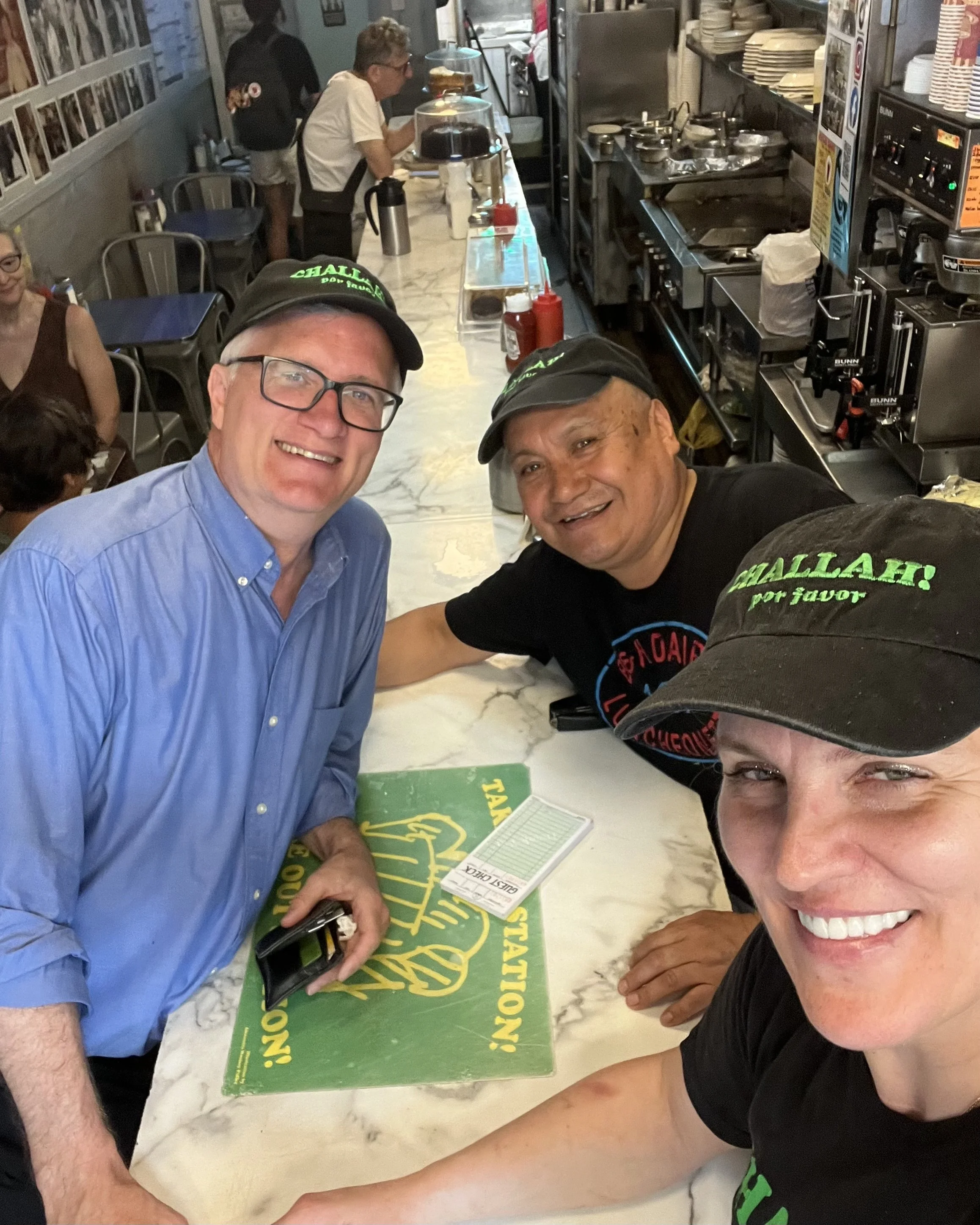 Senator-Brian-Kavanagh-with-BH-Dairy-owner-Ola-and-employee-Leo-at-counter.jpeg