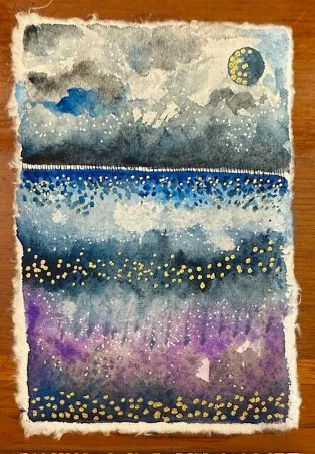 Midnight Sky was born quietly.

My sister and I sat on the hotel patio in Chiang Mai. Beyond the railing, the river softened the city. The sky moved slowly from purple to gold to deep blue.

We had spent the day walking the old city. Stone. Temples. 