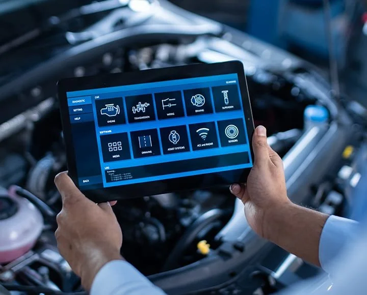 Person holding a digital tablet with car diagnostic settings in a vehicle's engine bay.
we use new technology to diagnostic vehicle for the real results