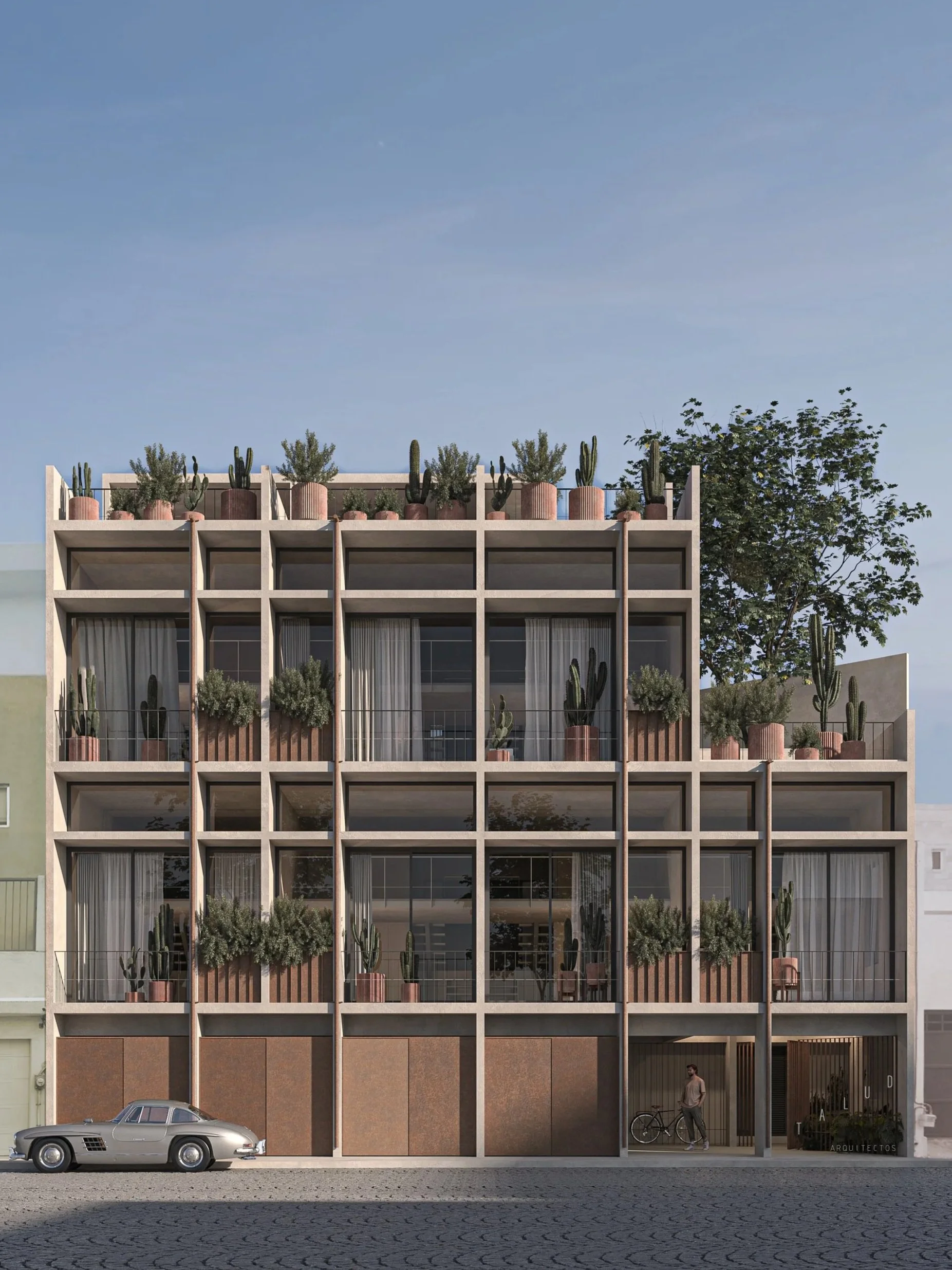 Edificio moderno de varios pisos con ventanas amplias y balcones decorados con plantas de cactus y arbustos. Hay un coche clásico estacionado en la calle frente al edificio y una persona con bicicleta en la entrada principal.