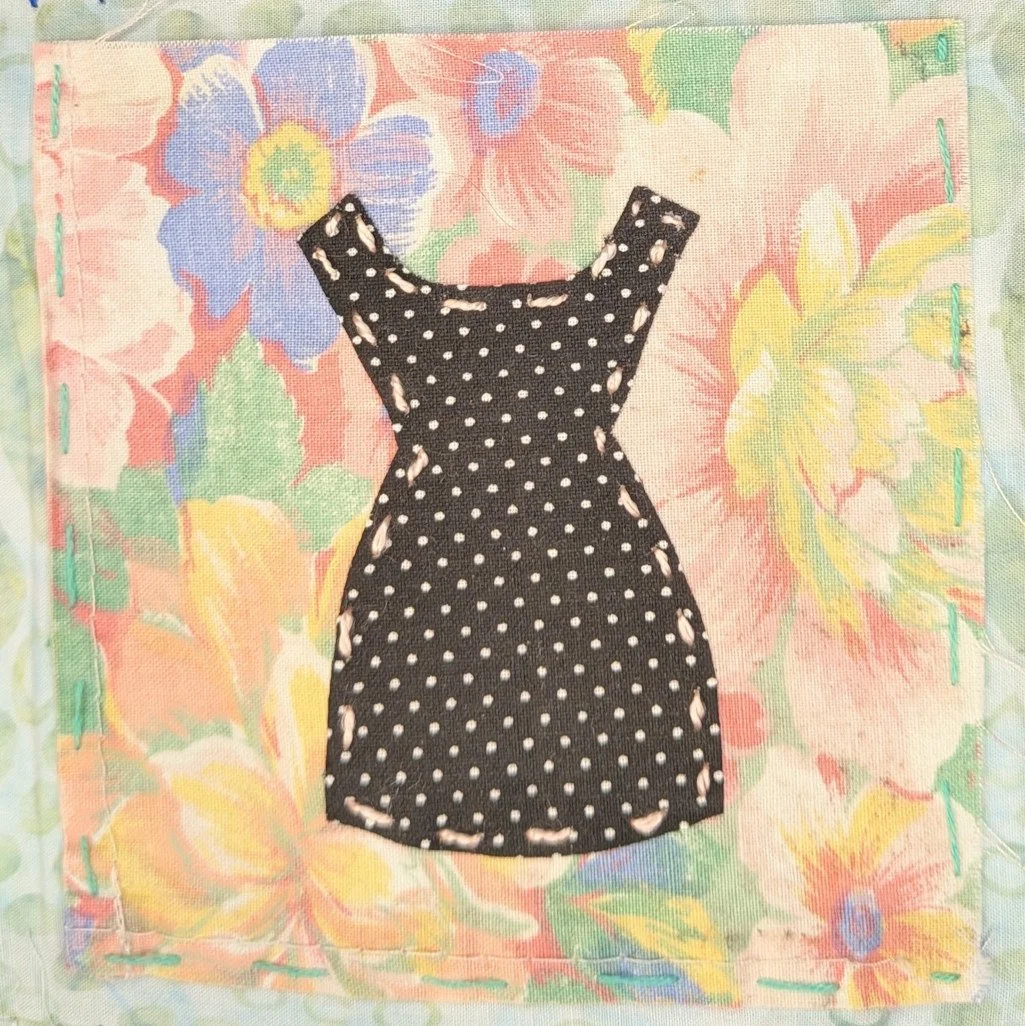 Sleeveless black dress with white polka dots on floral background