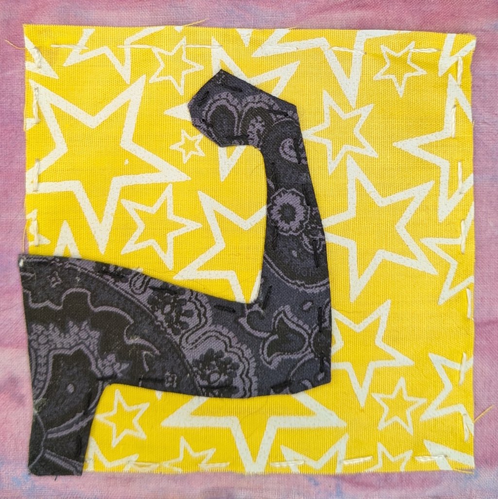 On yellow background, flexed black arm as power symbol