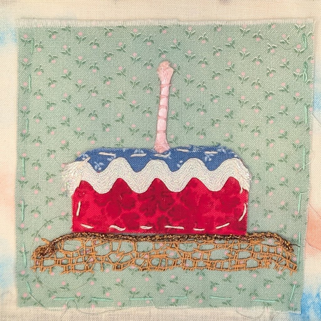 Red, white, and blue birthday cake with one pink candle