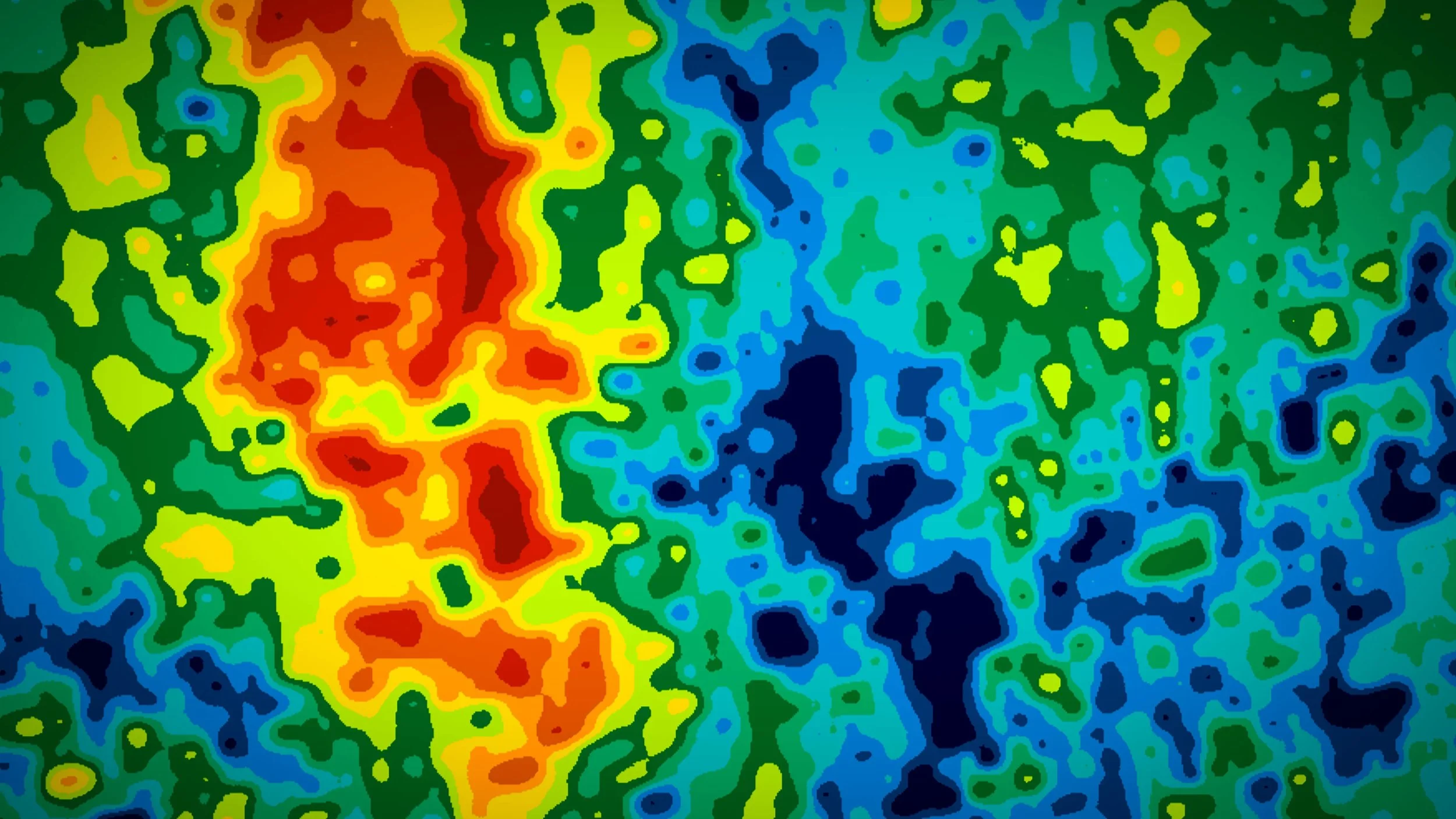 A colorful weather map with a large red and orange storm system on the left, surrounded by yellow, green, and blue areas indicating different weather conditions.