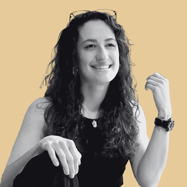 black and white photo of smiling woman with curly hair looking off into the distance