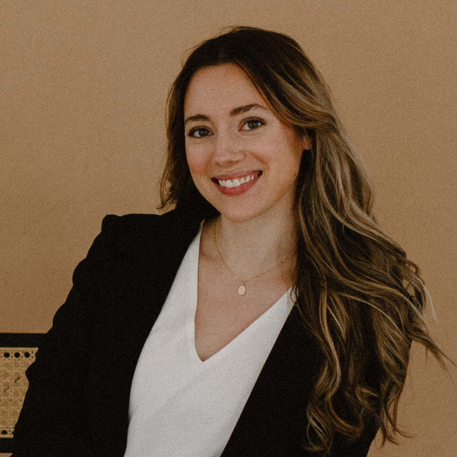 headshot of smiling woman wearing a blazer