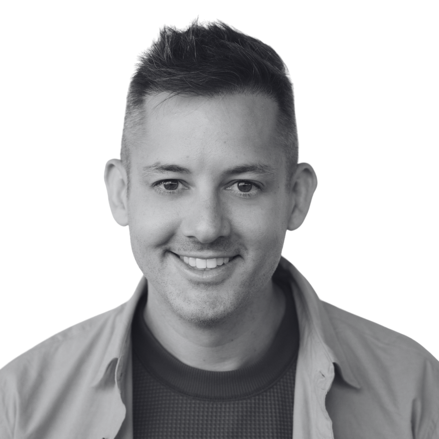 black and white photo of smiling man wearing open collared shirt over textured top