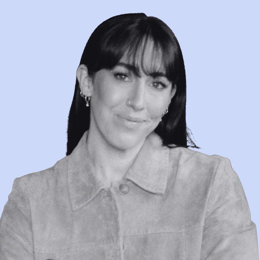 smiling woman with dark hair wearing a collared jacket
