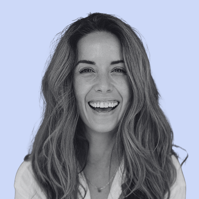 smiling woman with wavy hair on a light blue background