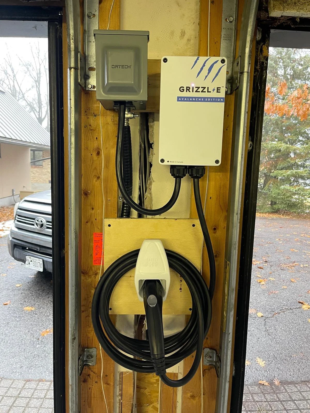 Grizzl-E EV charger installed beside an Ottawa garage entrance