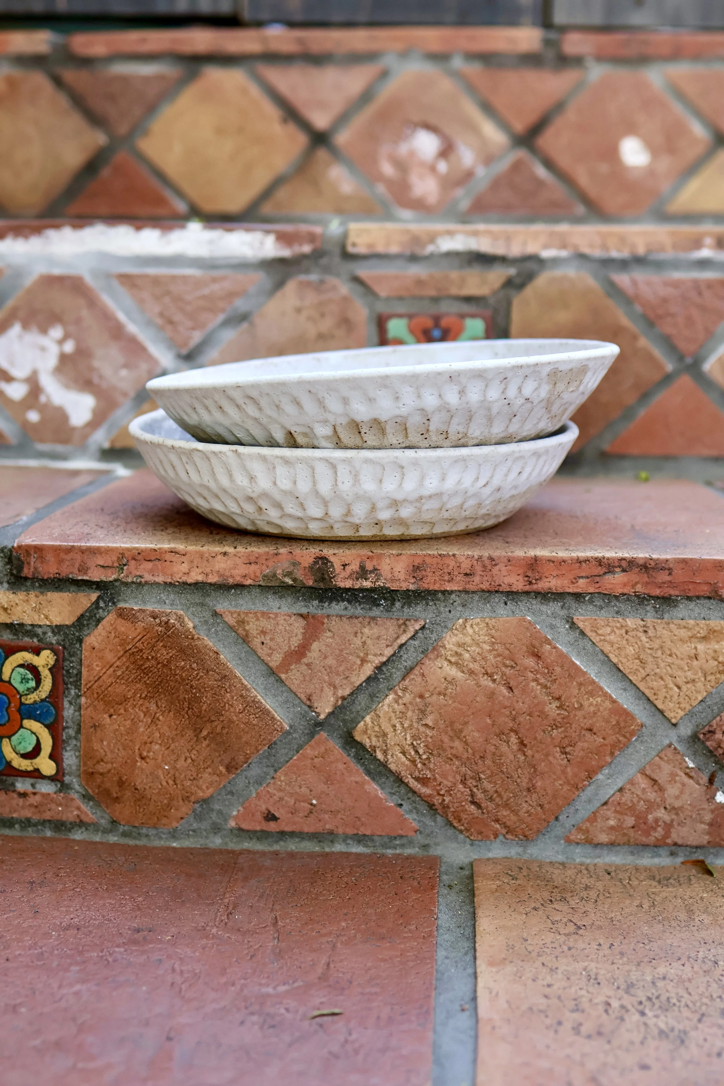 the underneath of a bowl with handcrafted words 'irisadre' on the bottom
