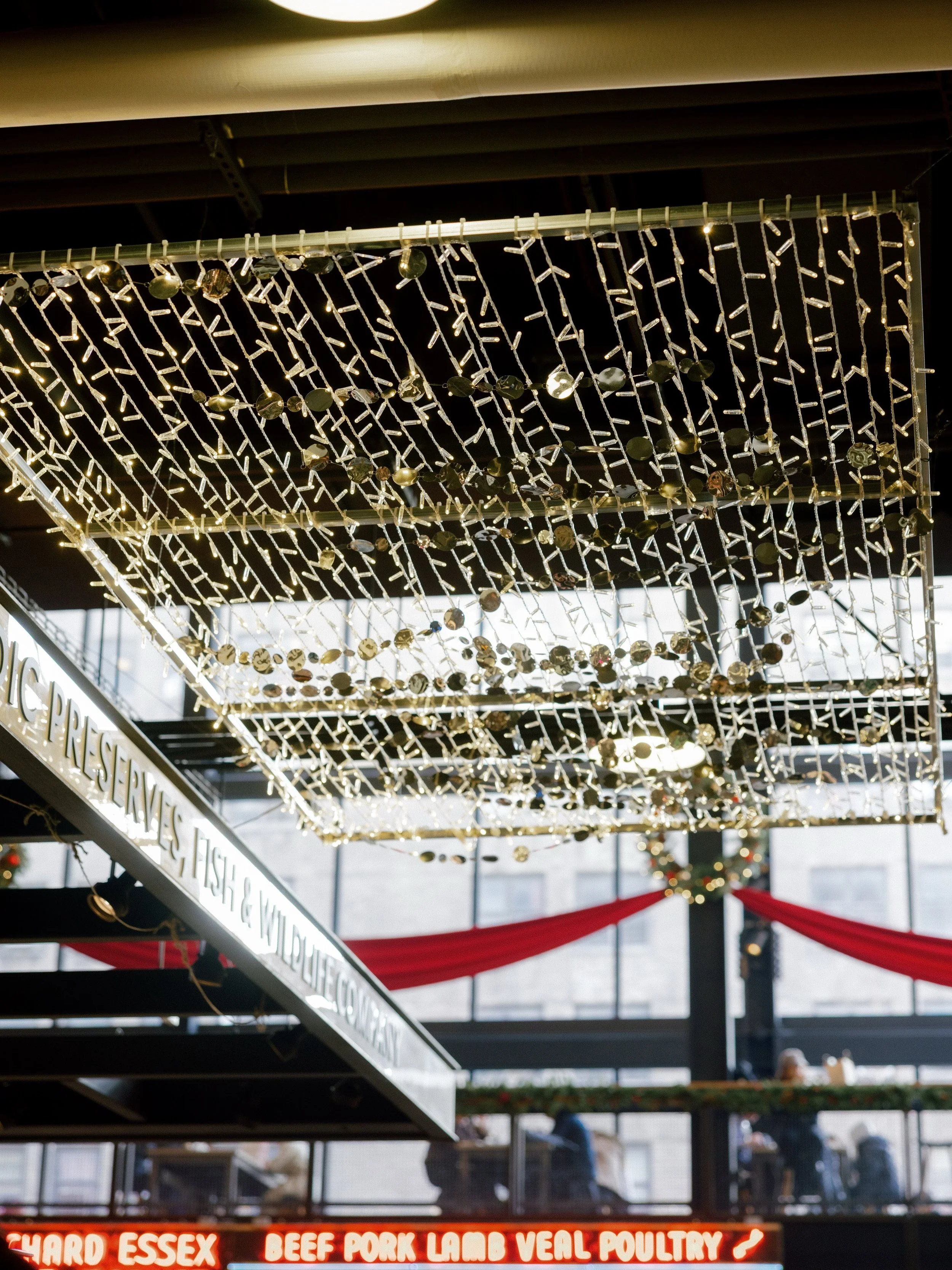 Creating holiday moments from above. Warm white lighting, layered textures, and a touch of shimmer transformed Essex Market for the season. 

#holidaycollective #nyc #les #lightartinstallation #customlighting