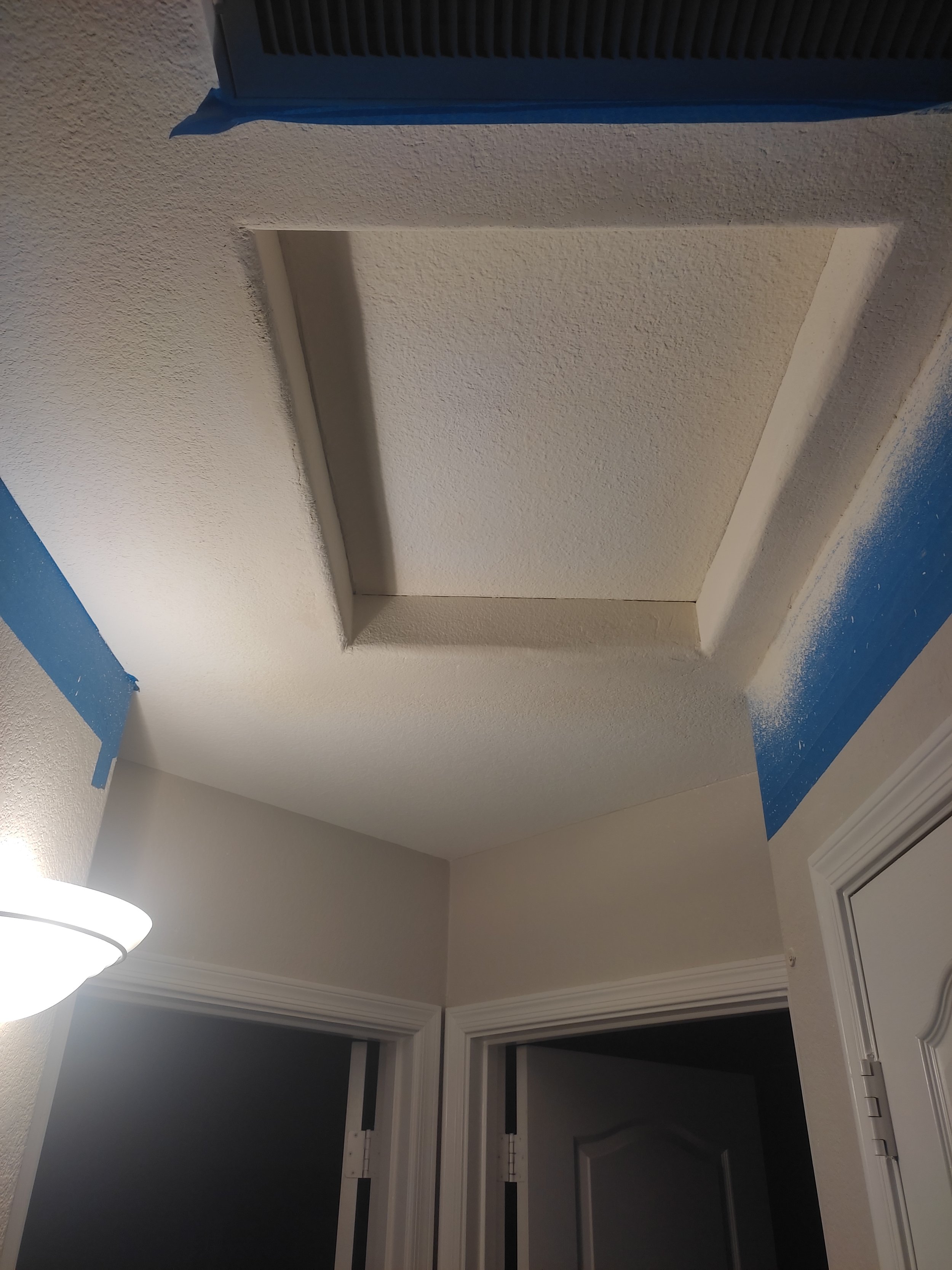 Ceiling access panel is covered with drywall.