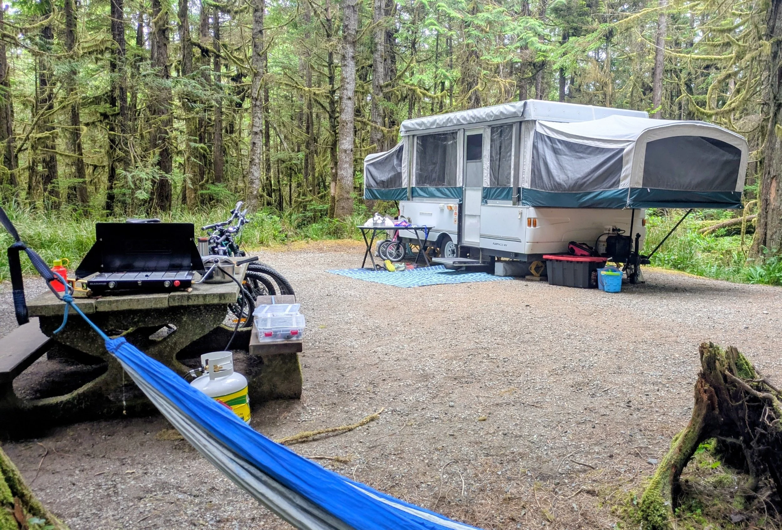 Tent trailer set up at a family campsite during a summer camping trip.