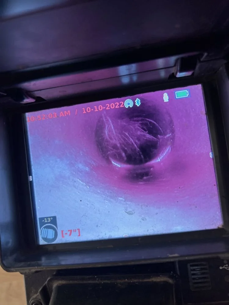 Sewer camera inspection showing a sewer line with root damage