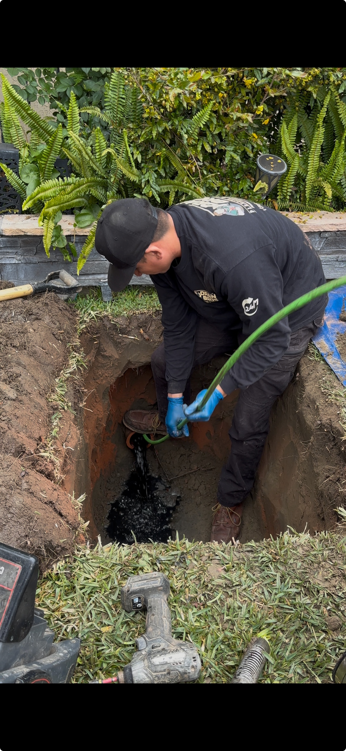 Drain Bros Pluming and Rooter technician performing a hydro jetter drain cleaning