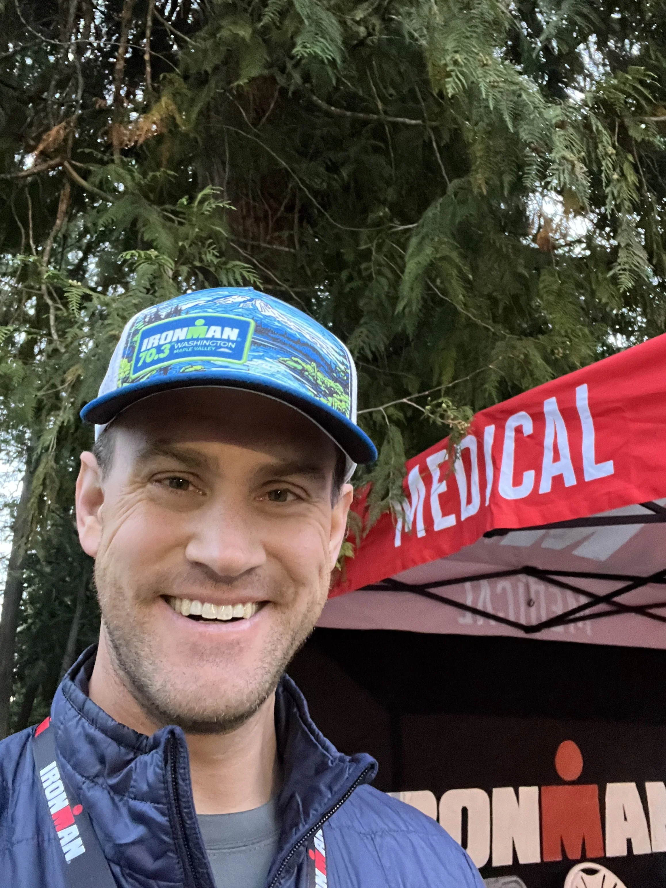 Smiling doctor in front of ironman medical tent
