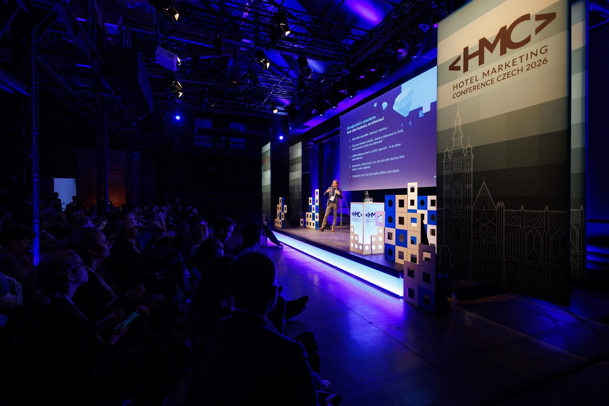 Wide view of a corporate conference space with networking and bar area, captured through event photography by Filip in Bratislava for Raccoon London.