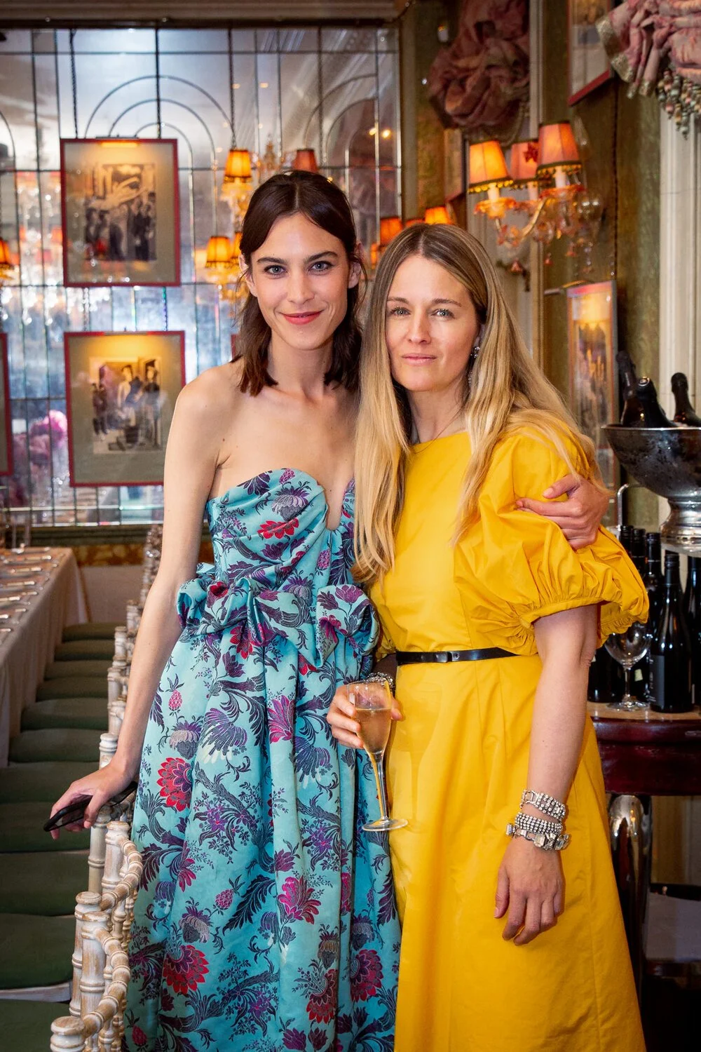 Two guests standing together for a portrait inside a restaurant during a corporate event.