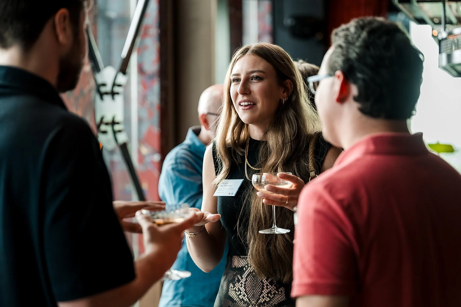  Conference delegates networking during an evening event at Money20/20 Europe. 