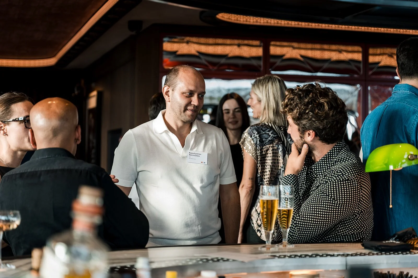  Guests networking at a fintech conference reception in Amsterdam. 