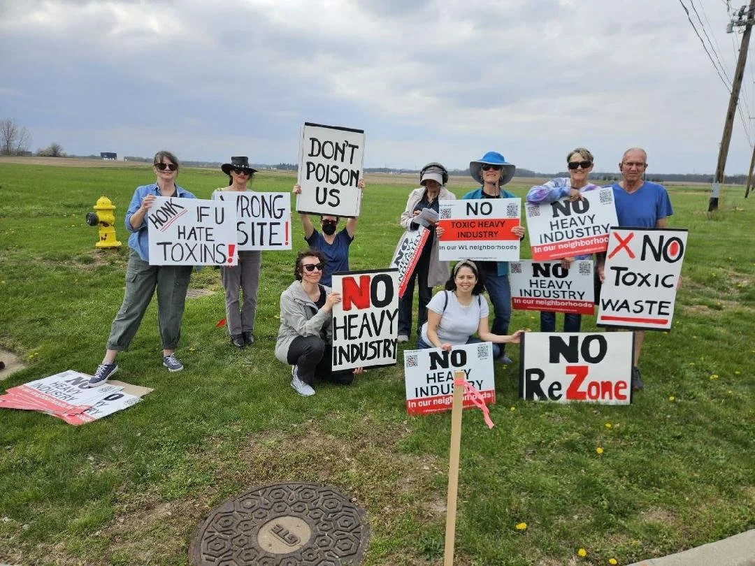 Group of residents hold signs opposing rezone
