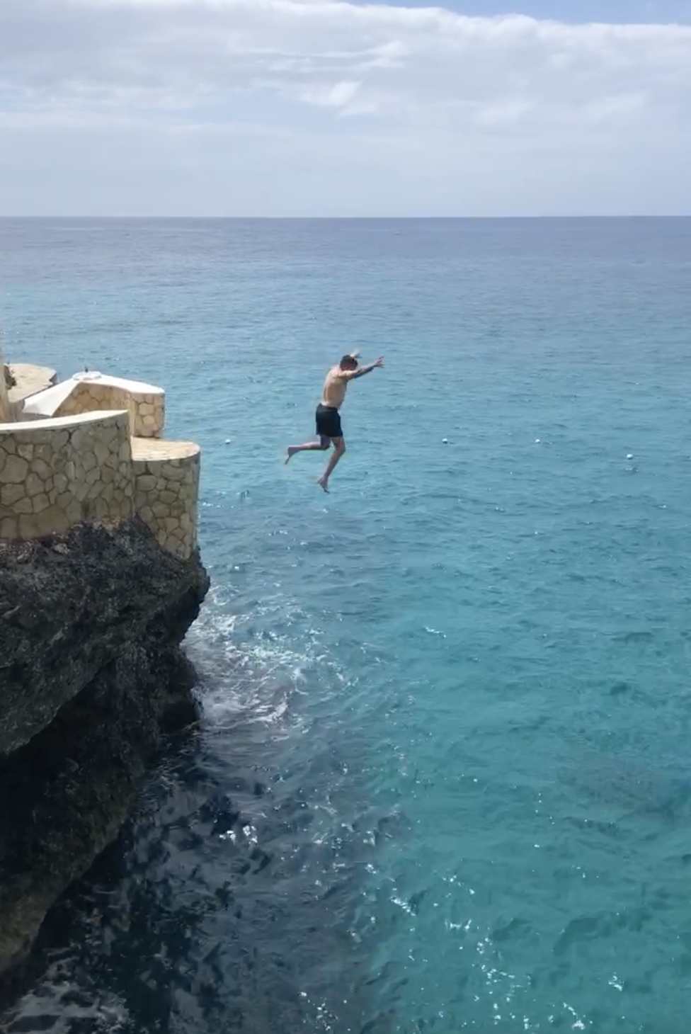 Patrick jumping off cliff in Jamaica reduced.png