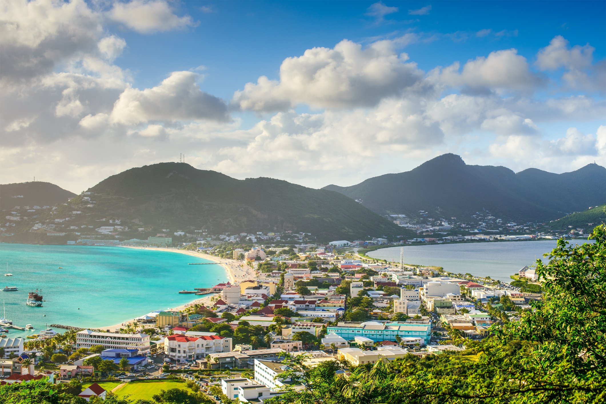 Aerial view of Marigot, the French-side capital of St. Martin, with terracotta rooftops, a sheltered harbor, and the Caribbean Sea stretching to the horizon