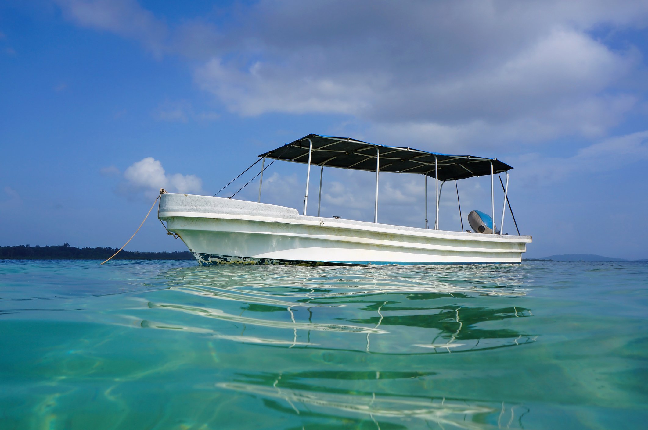 Boat without a person on it anchored in open sea in Bimini