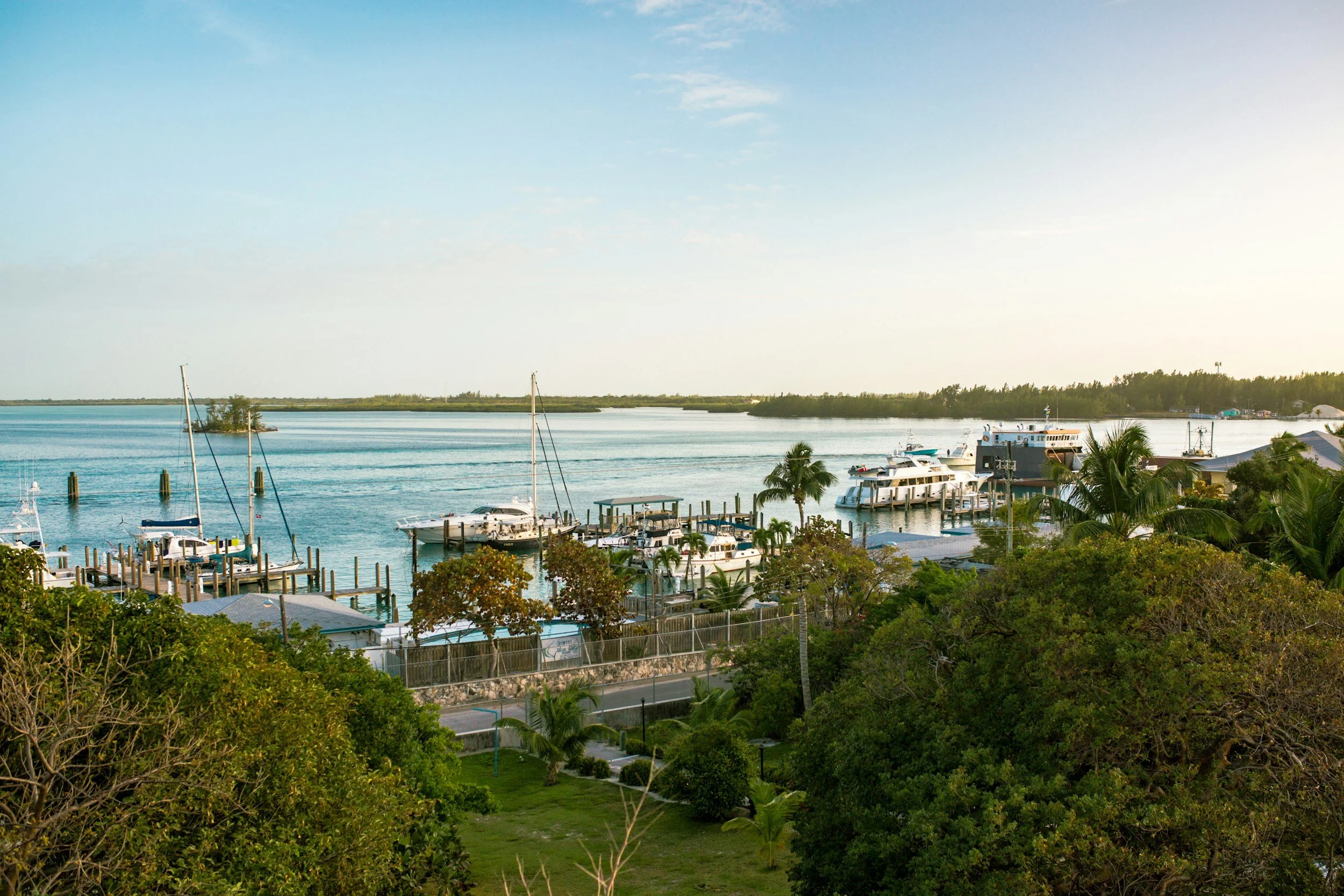 Several boats and yachts at a harbour in Bimini on a slightly overcast day