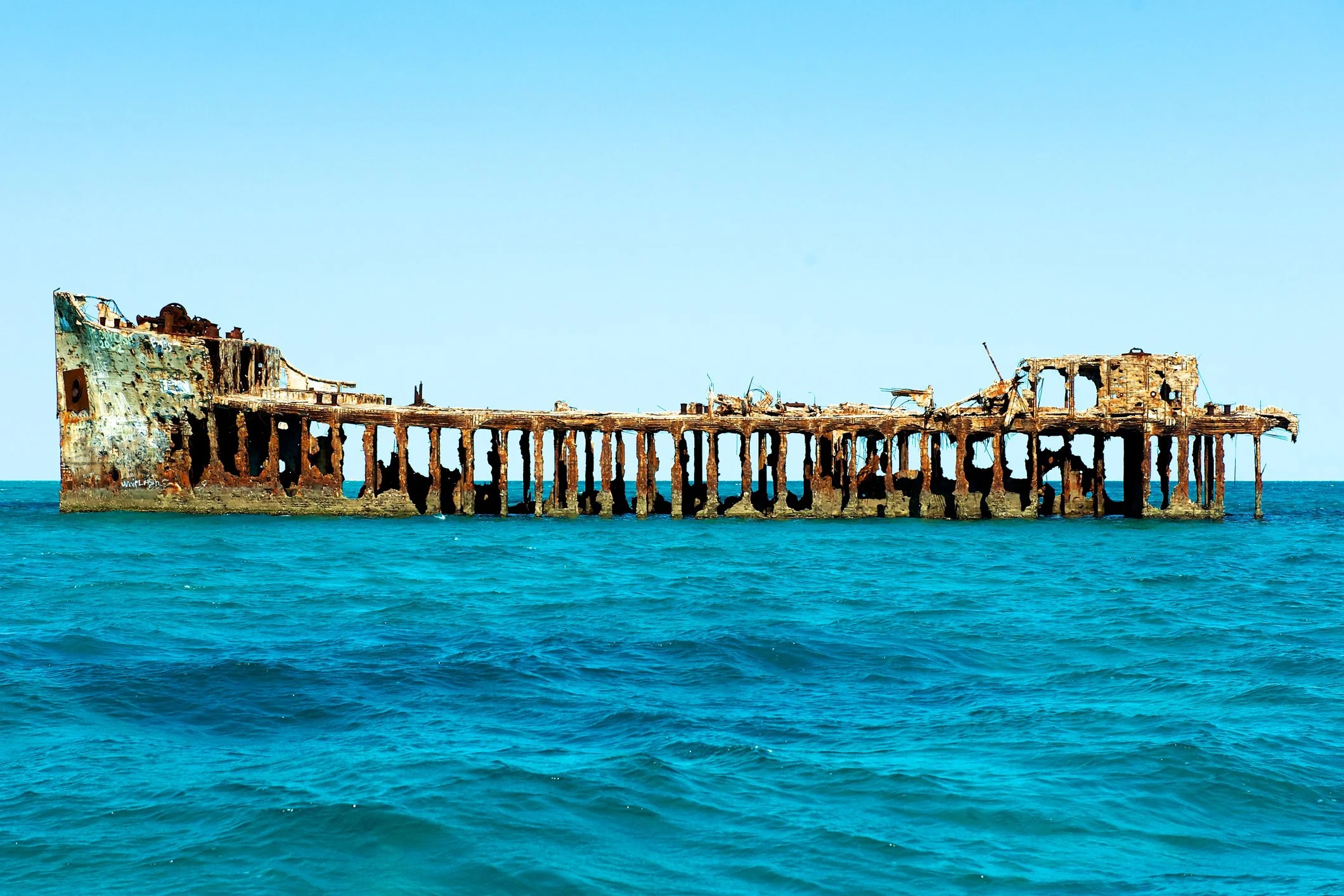 Remains of a sunken ship that is hollowed out in the water off the coast of Bimini