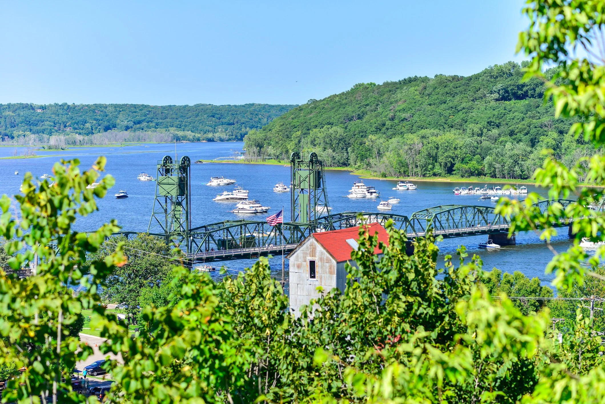 A view of a walking bridge in St. Croix with many boats on the far side of it.