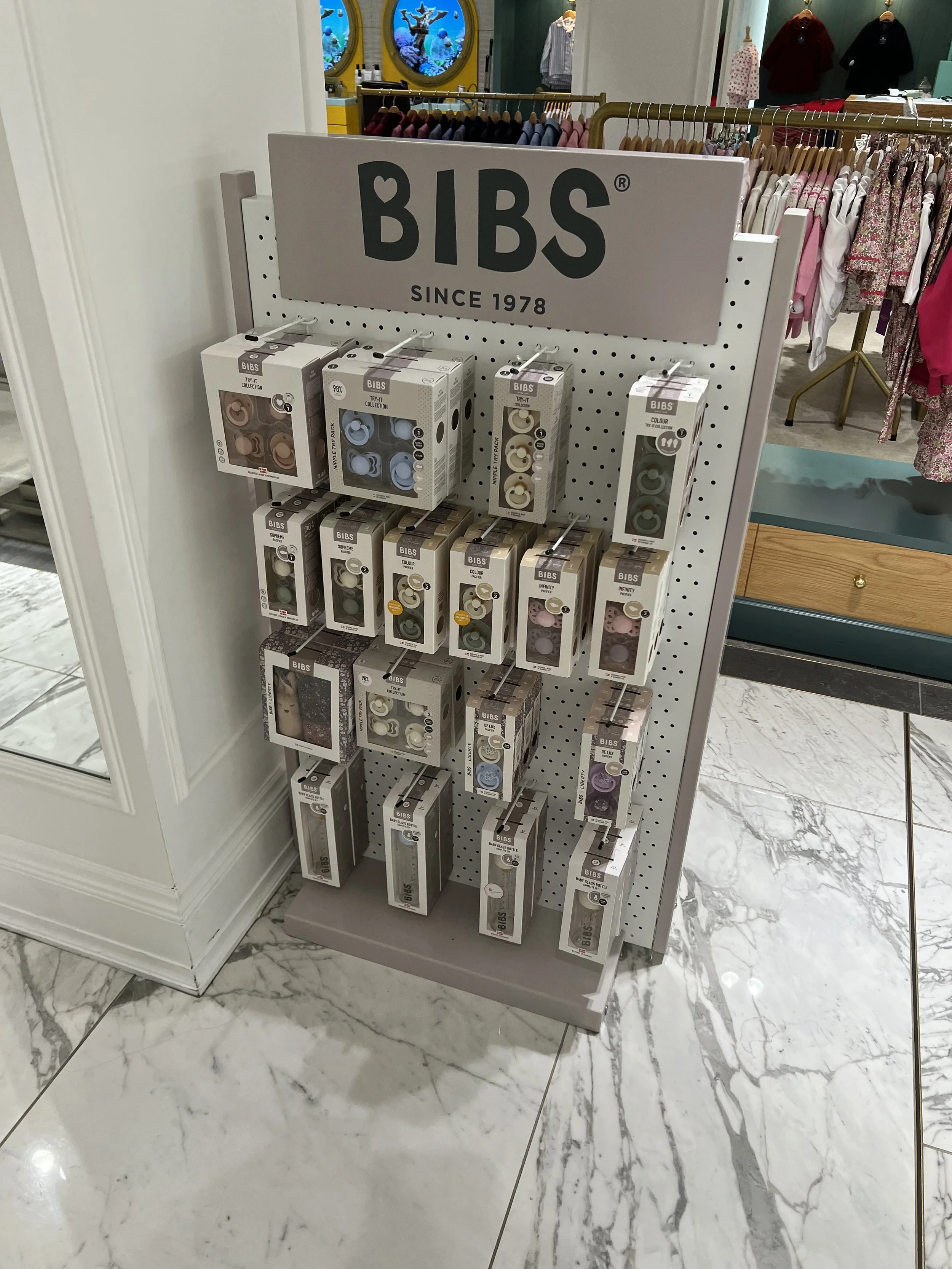Display of BIBS brand silicone teething clips and accessories in a retail store.