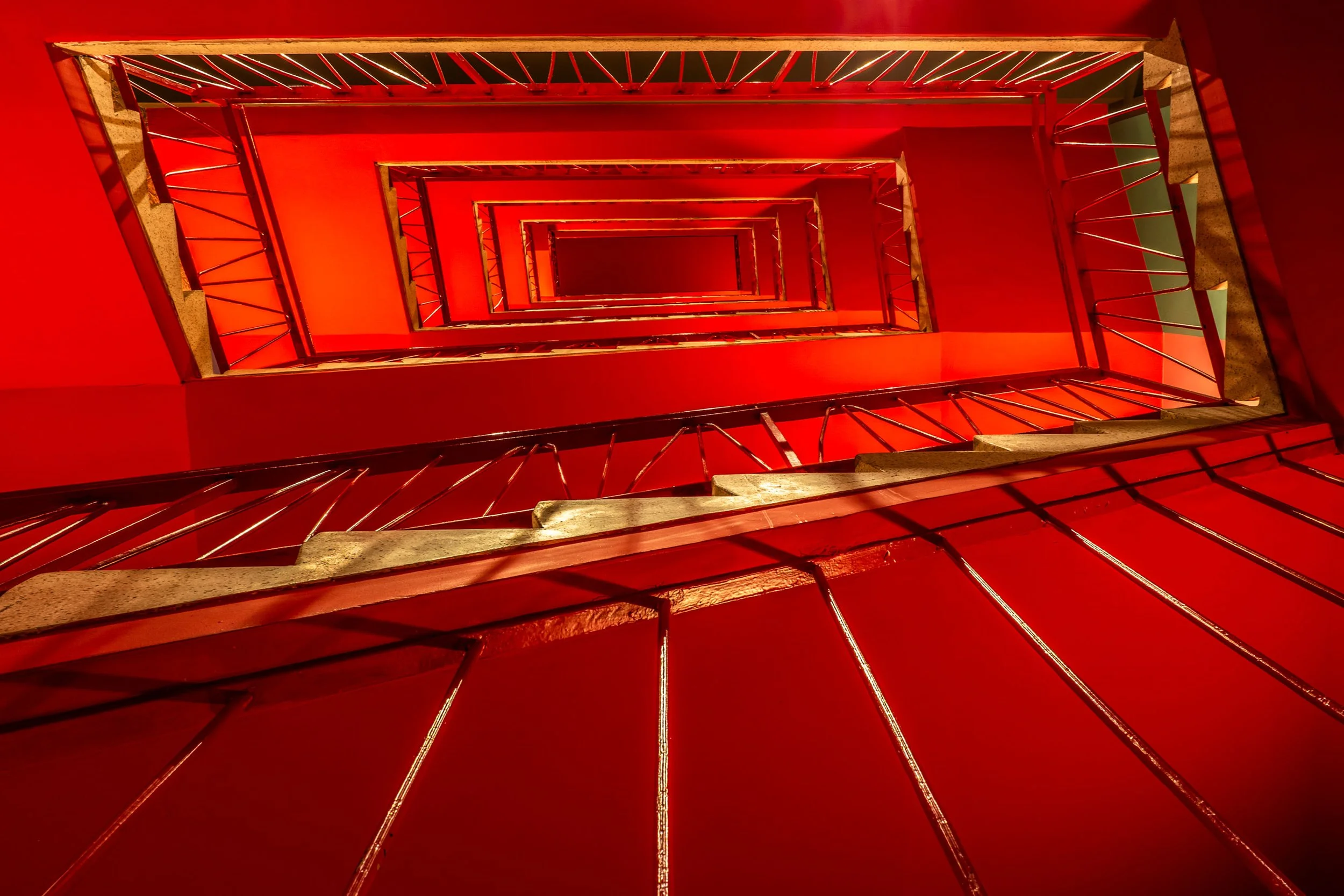 An architecture photograph of a bright red modern metal staircase taken on a Frankfurt photography tour
