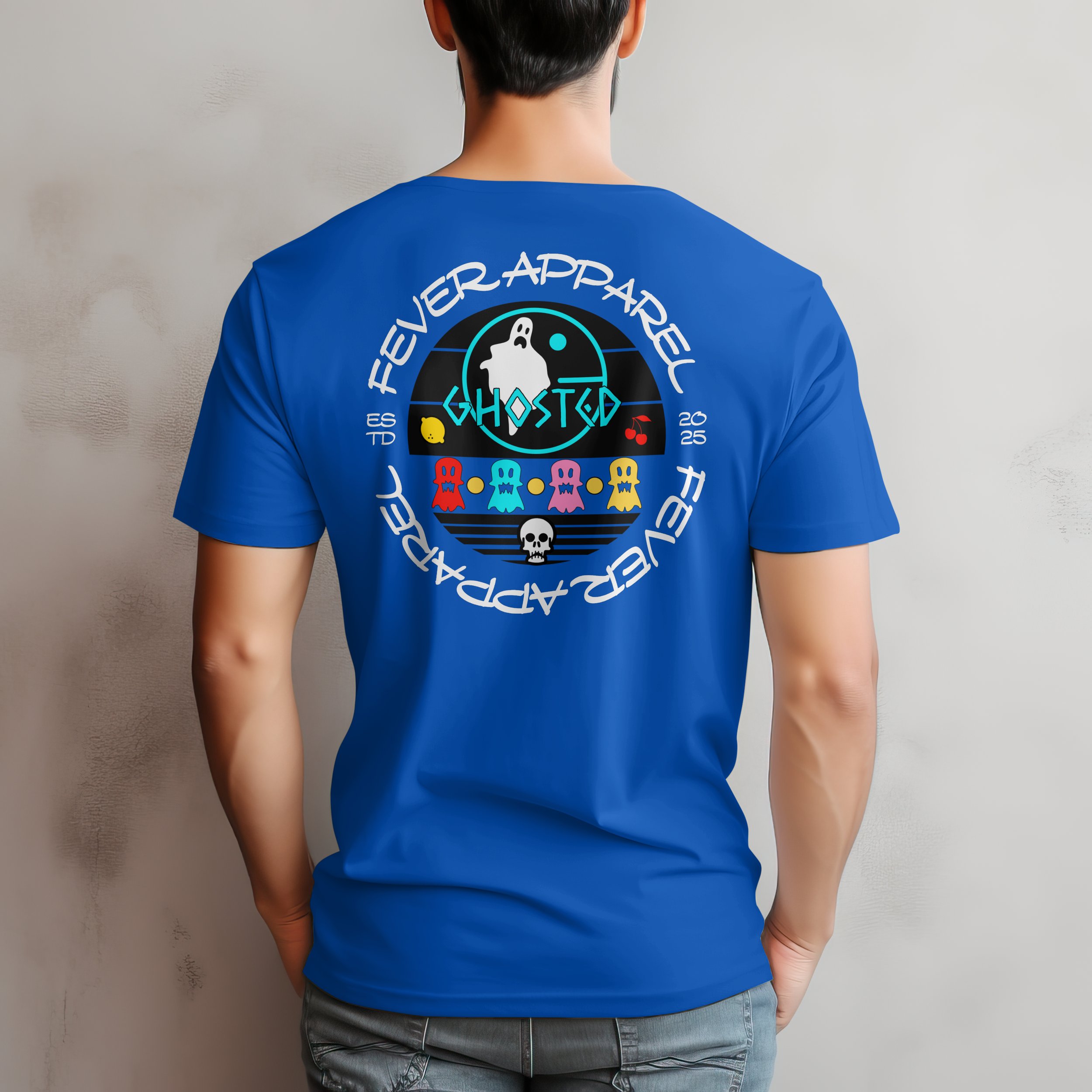 Back of a person wearing a blue T-shirt with a colorful graphic design and text that says "FEVER APPAREL" and "GHOSTED 2025."