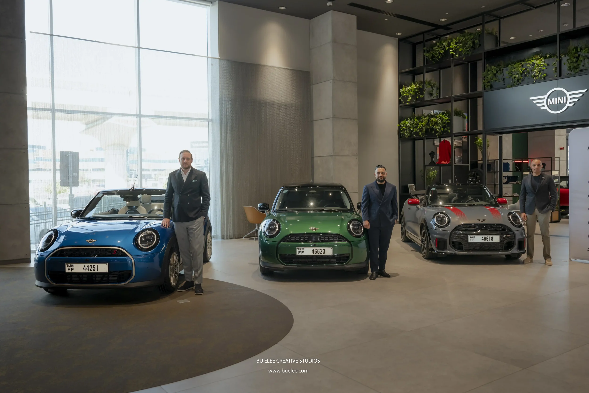 Senior members of both Udrive and AGMC Mini Cooper UAE posing for a photo next to the newly added vehicles into the fleet.