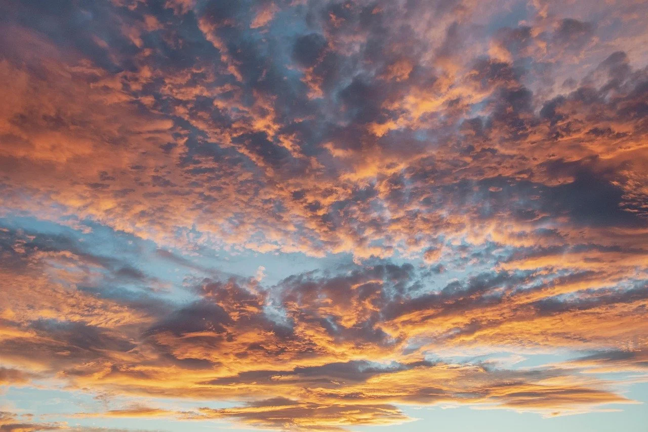 Colorful sunset sky with orange, pink, and blue clouds.