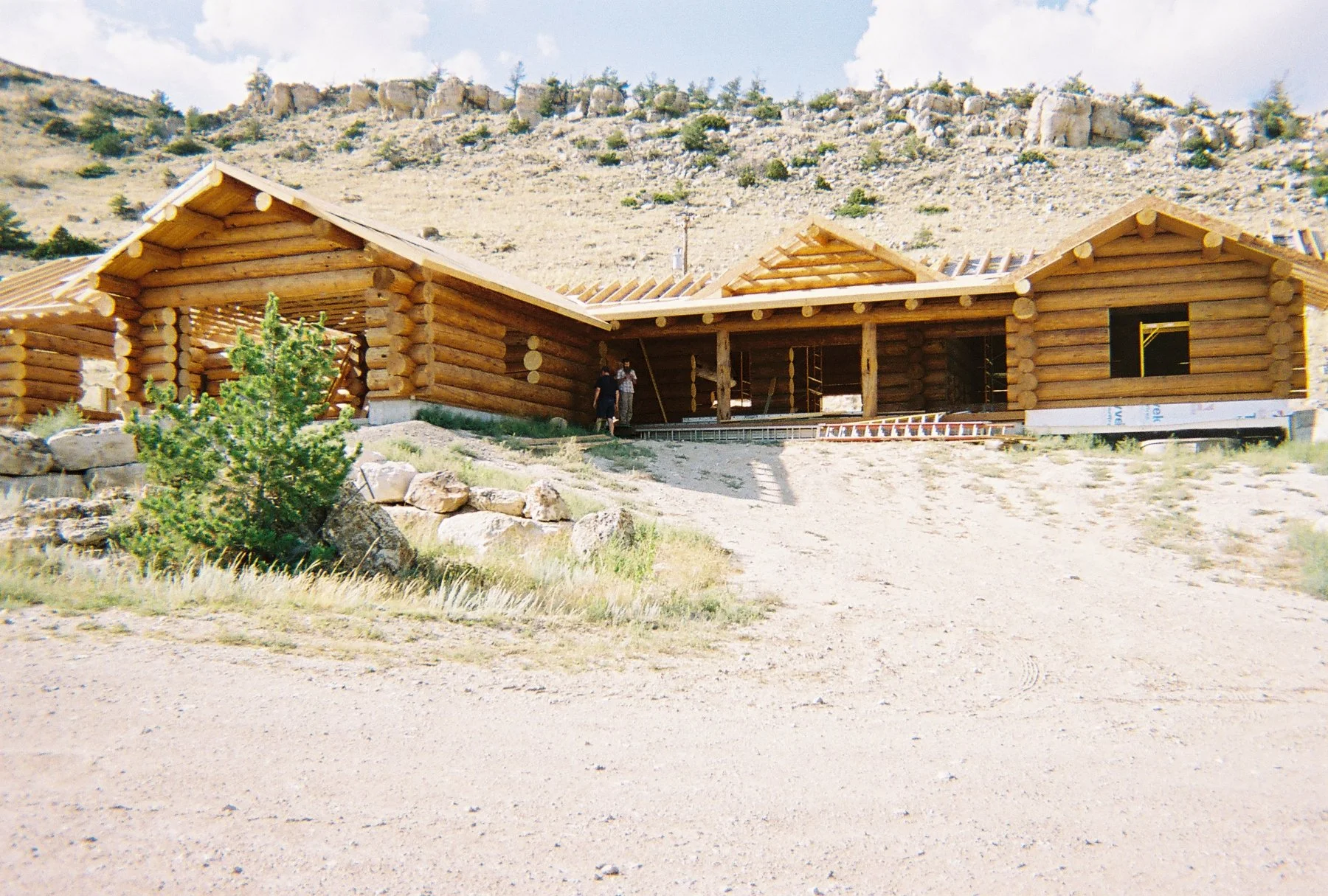 Log home with Bob and Nick on porch.jpg