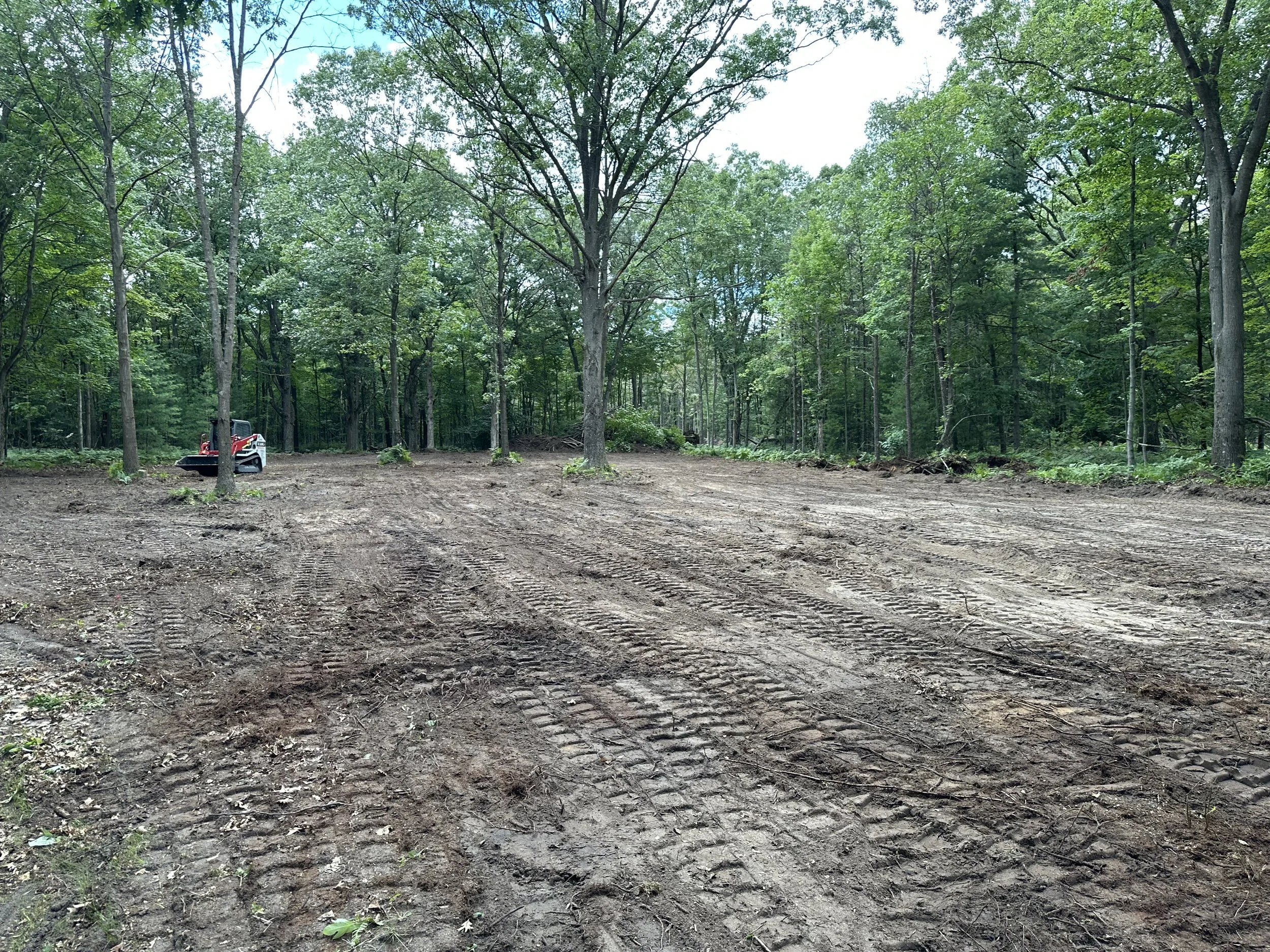 A previously wooded land area has been cleared and prepped for building a house