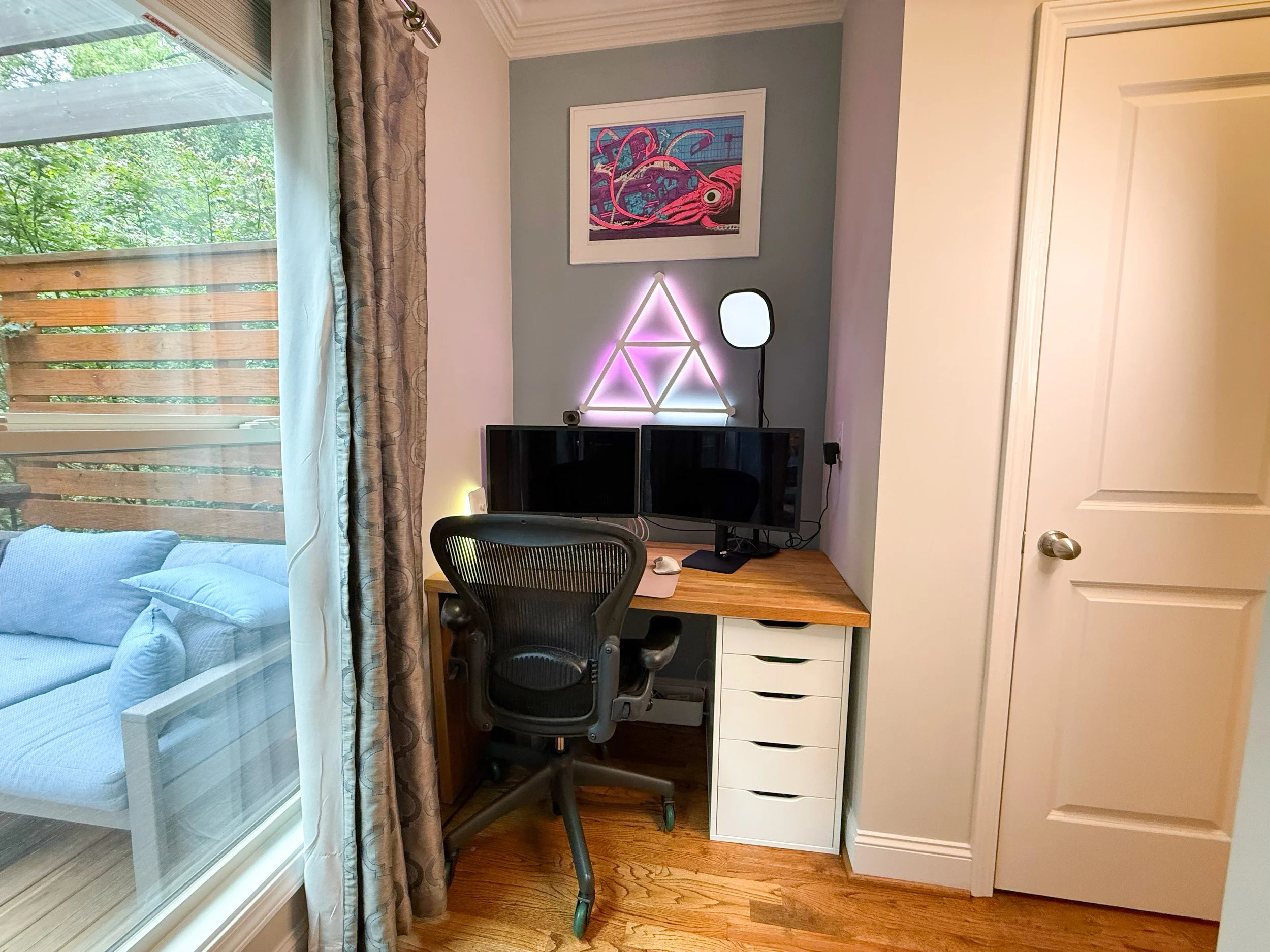 Cozy computer nook off the living room with a view of the deck — ideal for a home office or study space.